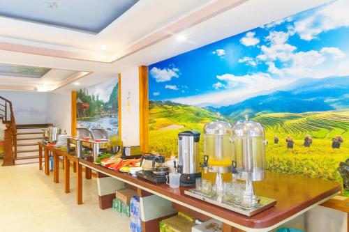 a restaurant with a mural on the wall at Long Anh Hotel in Lao Cai