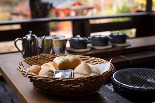 a basket of bread sitting on a table at ログコテージ茶臼の森 in Nasu