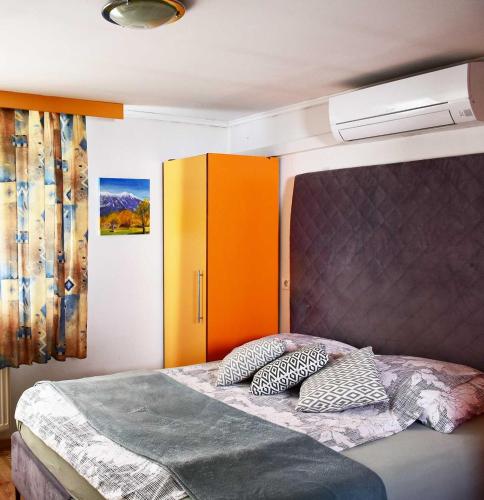 a bedroom with a bed with two pillows on it at Sobe - Rooms Stremljan Ljubljana in Medvode
