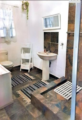 a bathroom with a sink and a toilet at Sundown Lodge and Confrence in Aliwal North