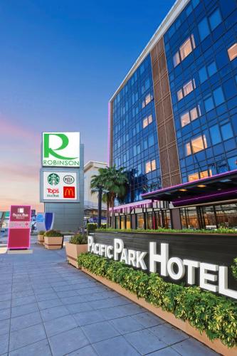 a park hotel sign in front of a building at Pacific Park Hotel in Si Racha