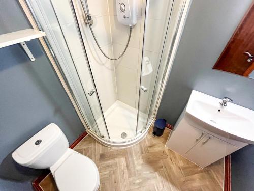 a bathroom with a shower and a toilet and a sink at Core Citi Lets, Guild Street Rooms in Aberdeen