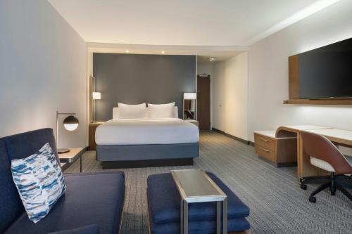 Courtyard by Marriott Redwood City في ريدوود سيتي: غرفة فندق مع سرير ومكتب