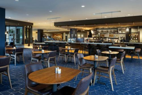 a restaurant with tables and chairs and a bar at Courtyard by Marriott Redwood City in Redwood City