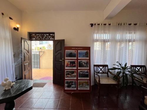 a living room with a door and a table and a room at RIVINSON Negombo in Negombo