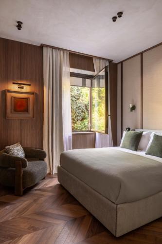 a bedroom with a large bed and a window at NAMAN HOTELLERIE - Roma in Rome