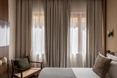 En eller flere senge i et værelse på NAMAN HOTELLERIE - Roma