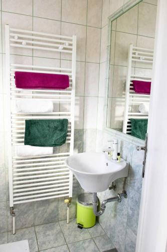 a bathroom with a sink and a mirror and towels at Sobe - Rooms Stremljan Ljubljana in Medvode