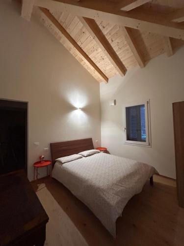 a bedroom with a bed in a room with a window at Emilia94 in Anzola dell'Emilia