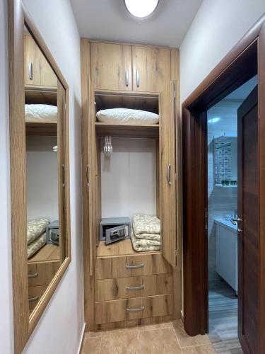 a room with wooden cupboards and a room with a window at Apartmani Resna Budva in Budva