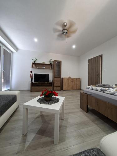 a living room with two beds and a table at Apartmán Wellness-Detva in Detva