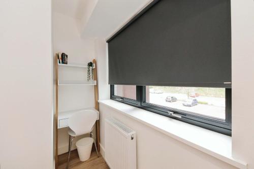 a room with a window with a black roller blind at Solihull Modern Living - 1 Bed Apartment in Solihull