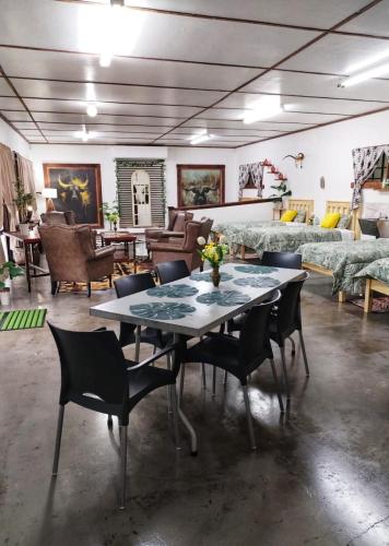 a room with a table and chairs and a couch at 2K City Studios Not Self catering in Graskop