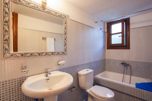 a bathroom with a sink and a toilet and a mirror at Μeropi & Natalia Villas in Skopelos Town