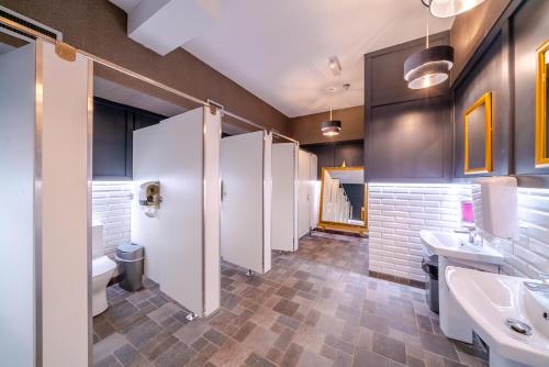 a bathroom with a row of sinks and toilets at The Gateway Hotel in Swinford