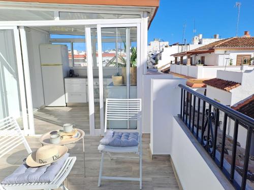 a balcony with two chairs and a table on a balcony at Noctua 012 Estepona Oldtown 3 in Estepona