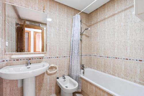 a bathroom with a sink and a toilet and a bath tub at Acag 135 in Orihuela