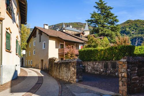 una calle de un pueblo con un muro de piedra en Maso Via Vecchia, en Ora - Auer
