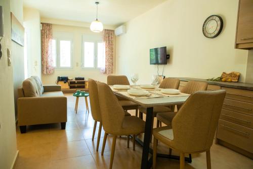 a dining room with a table and chairs at Eukalyptos 3BD apartment with yard in Chersonisos in Hersonissos