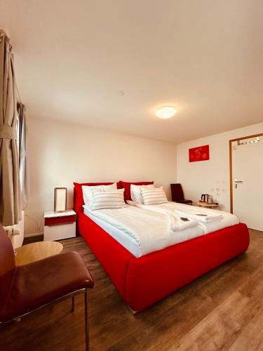 Romantic Room, Private Bathroom and Great View في هايدن: سرير احمر كبير في غرفة يوجد بها كرسي