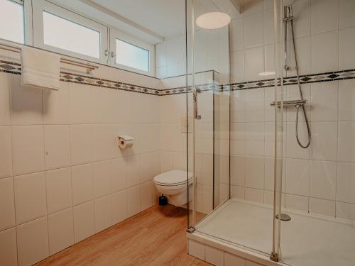 a bathroom with a shower and a toilet at Houseboat Uitgeest XL | 6 people in Uitgeest