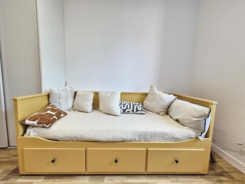 a bed with pillows on it in a room at La Pause Briochine in Saint-Brieuc