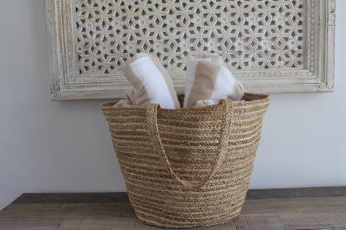 a basket sitting on the floor next to a wall at Beach Bound-Jervis Bay in Vincentia
