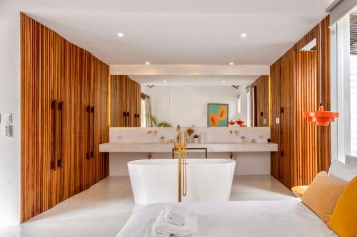 a bathroom with a tub in the middle of a room at Manao Villas - Luxury Boutique Resort in General Luna