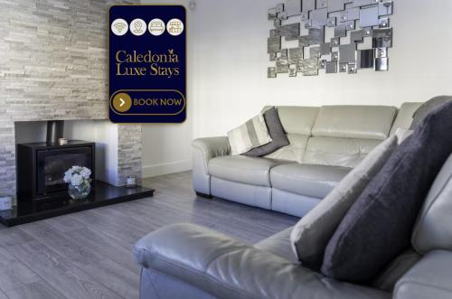 a living room with a couch and a fireplace at North Calder Haven in Airdrie