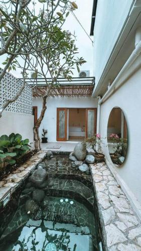 a swimming pool in the middle of a house at Chic 2BR Villa w/Rock Plunge Pool in Denpasar
