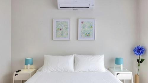 a bedroom with a white bed with two night stands at Ocean View! 2-Bedroom Cosy Condo in Portimão