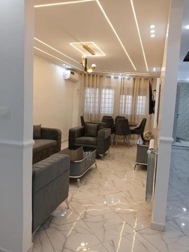 a large living room with couches and a table at Maison de repo in Mostaganem