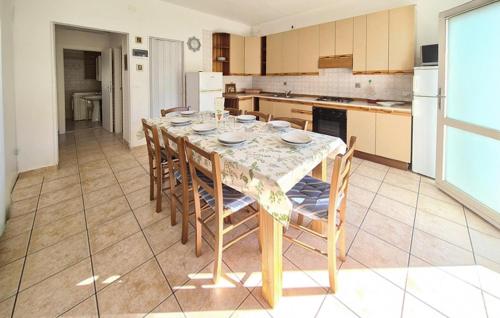 a kitchen with a table and chairs in a kitchen at Milla 2 in Rosolina Mare