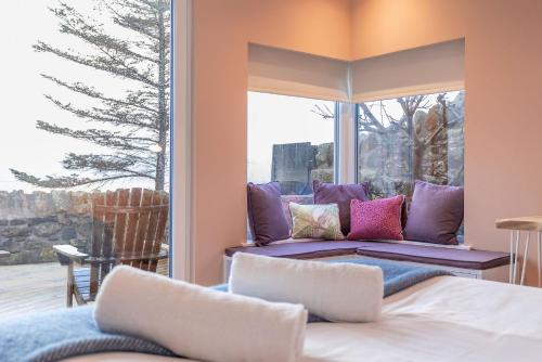 een slaapkamer met een bed en een groot raam bij The Deck House - St Monans in Saint Monance