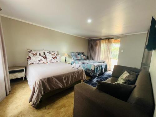 a bedroom with a bed and a couch at Lavender Lane in Denysville