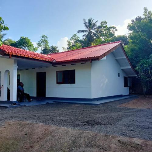 a house with a red roof at Cenesco Rest in Induruwa