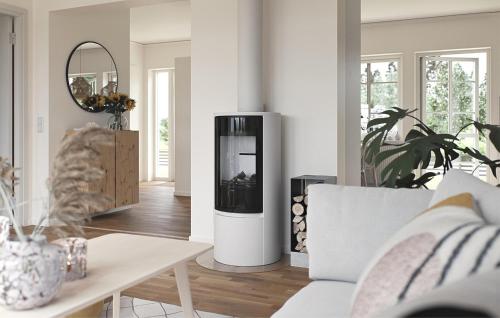 a living room with a white living room with a fireplace at 2 Bedroom Amazing Home In Färjestaden in Algutsrum