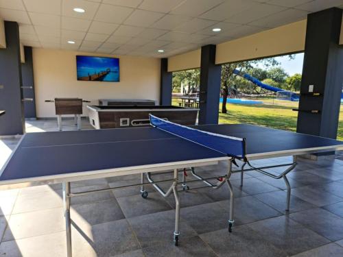 a ping pong table in a room with a pool table at Lethabong Lodge in Thabazimbi