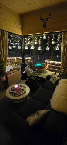 a living room with a couch and a table at Domek pod Kozińcem SAUNA JACUZZI Zakopane in Zakopane