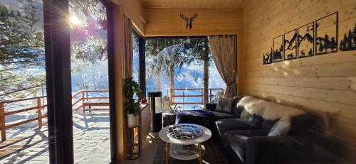 a living room with a couch and a table at Domek pod Kozińcem SAUNA JACUZZI Zakopane in Zakopane