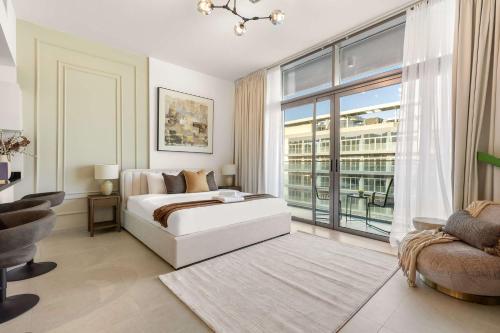 a bedroom with a white bed and a large window at Silkhaus Vacation Homes Holiday Studio Retreat in Saadiyat Island in Abu Dhabi