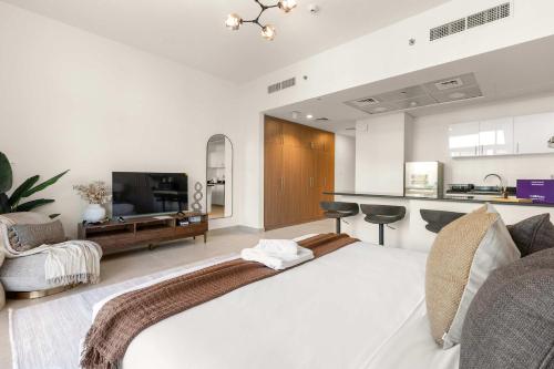 a living room with a bed and a kitchen at Silkhaus Vacation Homes Holiday Studio Retreat in Saadiyat Island in Abu Dhabi