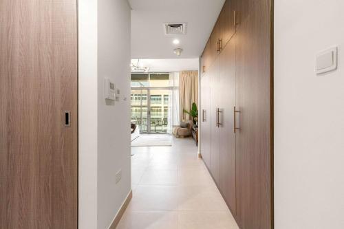 a hallway with wooden cabinets and a hallway with a hallway at Silkhaus Vacation Homes Holiday Studio Retreat in Saadiyat Island in Abu Dhabi