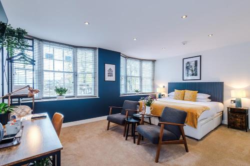 a bedroom with a bed and a table and chairs at Riverside Studios in the Centre of Chester in Chester