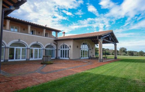 an exterior view of a house with a patio at Beautiful Home In Ansedonia in Ansedónia