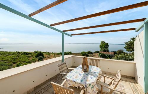a patio with a table and chairs on a balcony at Stunning Home In Carloforte With Wifi in Carloforte