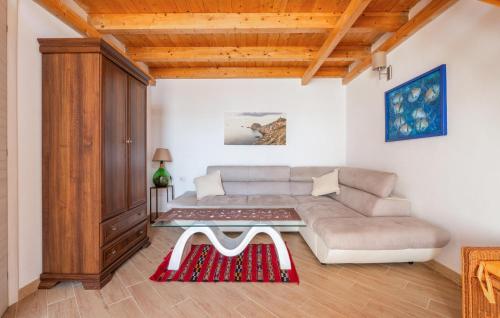 a living room with a couch and a table at Stunning Home In Carloforte With Wifi in Carloforte