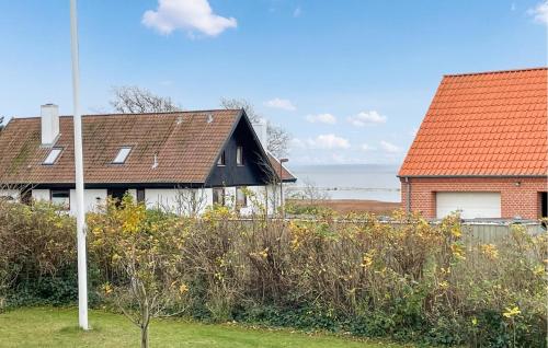 two houses with red roofs in a yard at Gorgeous Home In Assens With Wifi in Assens