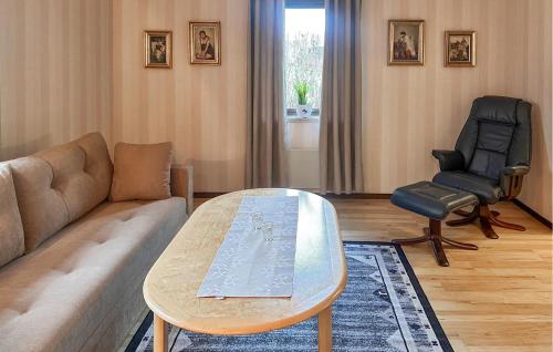 a living room with a couch and a table and a chair at 1 Bedroom Amazing Apartment In Hultsfred in Hultsfred
