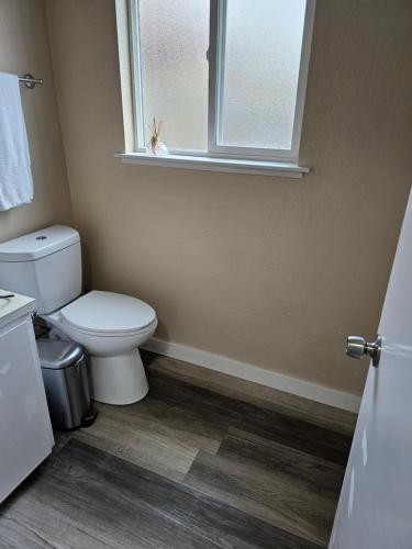 a bathroom with a toilet and a window at Marine B Two Bedrooms One-Half Bathrooms Townhouse in Everett
